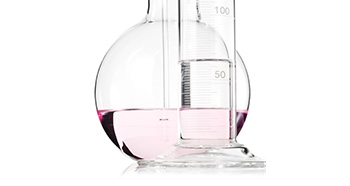 Visual representation from Mary Kay of retinol as scientific glassware holding clear and pink liquid against a white background